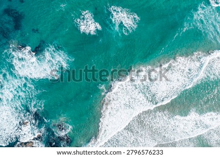 Violent ocean swells breaking into seafoam from above The Concept of natural forces