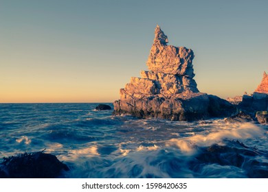 The violent waves dashed against the rocks by the sea