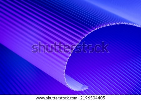 Violet and blue illuminated corrugated shapes. Geometric abstract background.