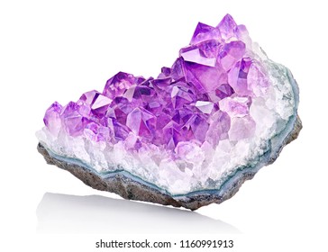 Violet Crystal Stone macro mineral. Purple rough Amethyst quartz crystals geode on white background, Uruguay