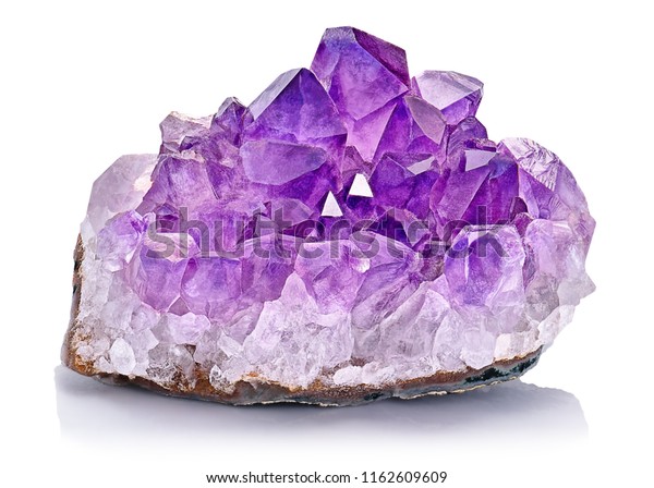 Violet Crystal Stone
macro mineral. Purple rough Amethyst quartz crystals geode on white
background, Uruguay