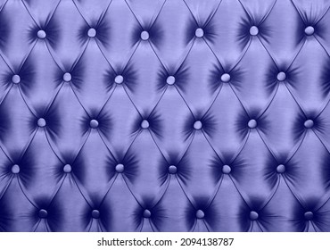 Violet lavender capitone textile background, retro Chesterfield style checkered soft tufted fabric furniture diamond pattern decoration with buttons, close up