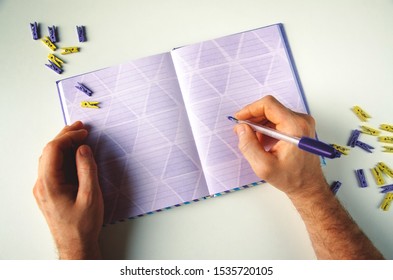 Violet notepad on the table. Office clothespin infashion purple colors. Color of 2020 year, place for text. 