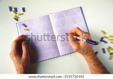 Violet notepad on the table. Office clothespin infashion purple colors. Color of 2020 year, place for text. 