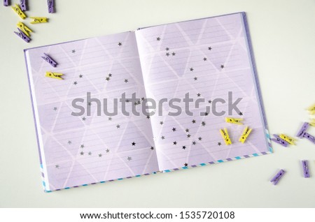 Violet notepad on the table. Office clothespin infashion purple colors. Color of 2020 year, place for text. 