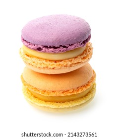 Violet orange and orange yellow macarons with yellow filling on isolated white background one on the other
