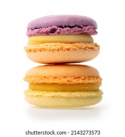 Violet orange and orange yellow macarons with yellow filling on isolated white background one on the other, side view