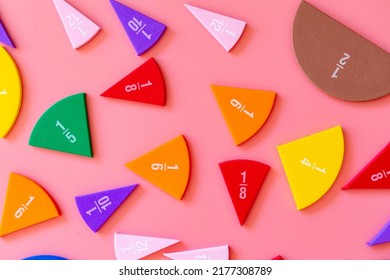 Violet orange yellow pieces of fractions on a table. Close up math material for study. Back to school, geometry lessons, mathematical education for preschooler. Creative study. background with numbers - Shutterstock ID 2177308789