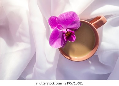 Violet Orchid Flower Pink Cup Of Latte Coffee With Milk White Tulle  Wood Background, Top View Flatlay Morning