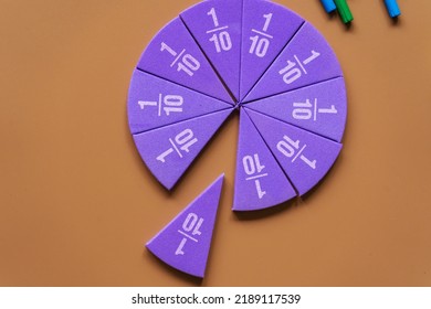 Violet pieces of fractions on a table. Close up math material for study. Back to school, geometry lessons, mathematical education for preschooler. Creative study. background with numbers - Shutterstock ID 2189117539