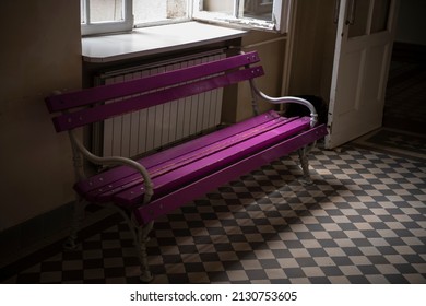 Violet And Purple Outdoor Wooden Bench Under The Window Light In Empty School Hallway. Vintage Floor And Bench Interior.