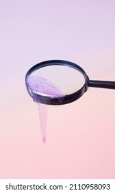 Violet Slime Dripping Off Of A Magnifying Glass On A Gradient Pastel Background. Global Warming Research Background.