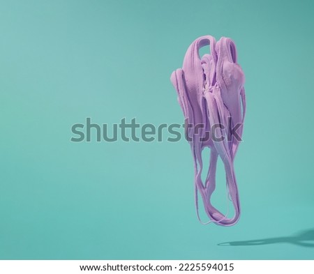 Violet soft clay bubble gum shape floating over teal background. Artistic retro futurism