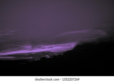 Violet sunset and black clouds