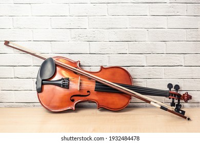 Violin And Bow, Show Design And Part Of Acoustic Instrument, Vintage And Art Tone On Brick Wall Background. Music Concept, Copy Spaces. 