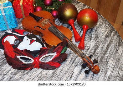 Violin, Carnival Masks, Maracas, Spruce Branch And Christmas Decorations.