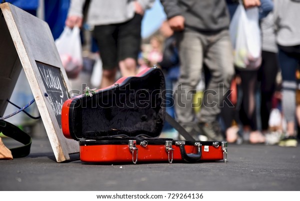 Violin case opens\
for donating money and coins on street, Buskers performing arts in\
public for money.