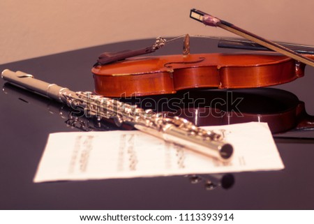 Violin and flute on the piano