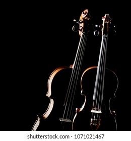 Violin Isolated. Duet Of Two Violins. Classical Music Instruments Of Orchestra. Violin And Viola String Instrument Isolated On Black Background