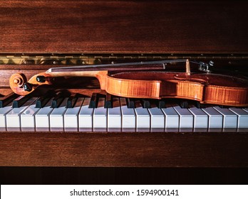 Violin lies on piano keys