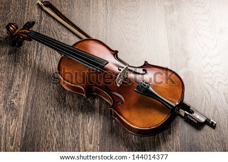 violin lying on a wooden textured table