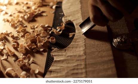 Violin making. Back arch with wood chips around - Powered by Shutterstock