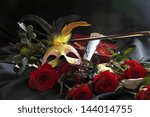 violin, a mask and a rose on a black background