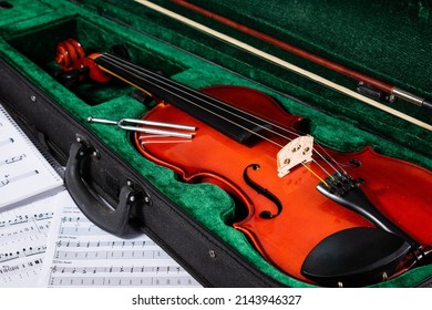 Violin Next To Sheet Music. Copyspace. Sheet Music Fiddle. Musical Instrument. String Instrument. Classical Musical Instrument. Violin In Its Box