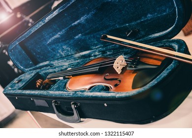 Violin on its case. Blue velvet violin case at music store