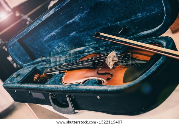 Violin on its case. Blue velvet violin case at\
music store