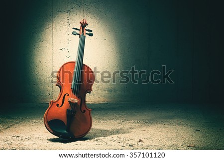 Violin on concrete wall background