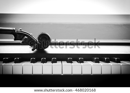 Violin on piano. Black and White color tone. Art and music concept. Still life and high contrast style. With dark vignette.