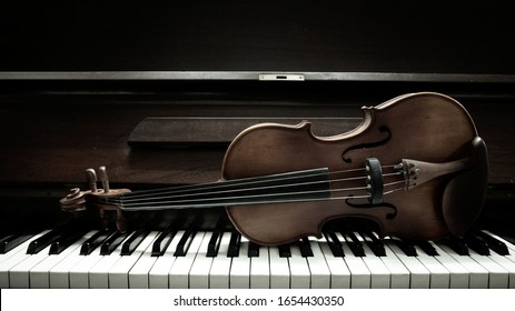 violin on piano keys top.