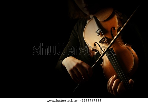 Violin player. Violinist hands playing violin\
orchestra musical instrument\
closeup