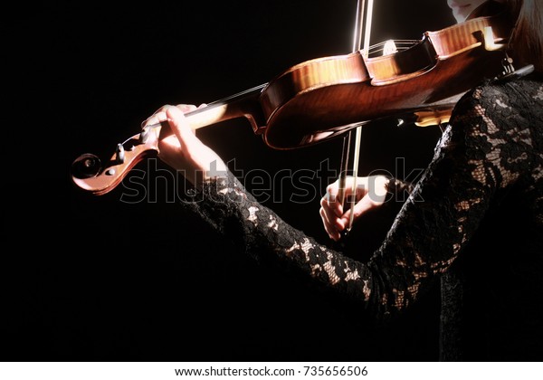 Violin player. Violinist playing violin Hands
with musical instrument close
up