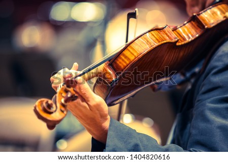 A violinist in concert with an orchestra