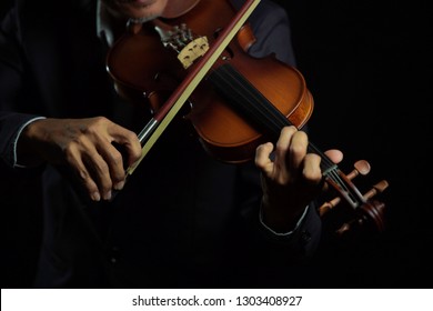 Violinist player hands close up shot  in black isolated background                        