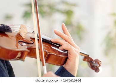 Violinist player musician in orchestra hands playing classical music on violin