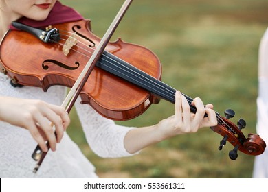 Violinist Woman. Young Woman Playing A Violin Outside.