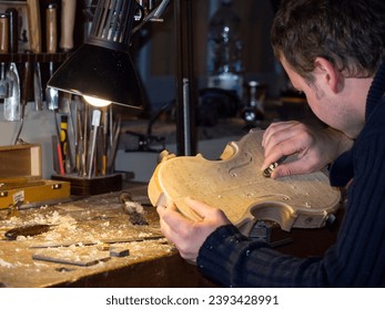 violn maker at work with new hand made violin carving table
 - Powered by Shutterstock