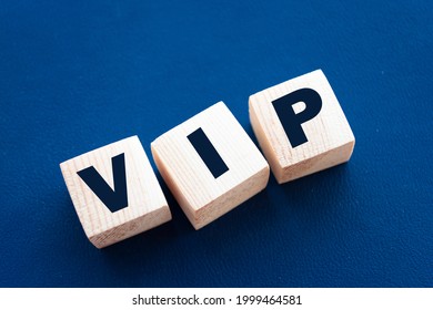 VIP Very Important Person text on wooden cubes on blue. Business concept.