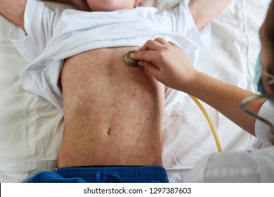 Viral Disease. Measles Rash. Concept Doctor And Patient. Doctor Listens With A Stethoskope Of A Child Sick’s Measles