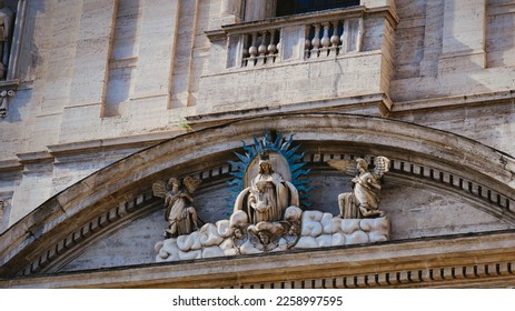 Virgin Mary with baby Jesus, statue on the church facade - Shutterstock ID 2258997595