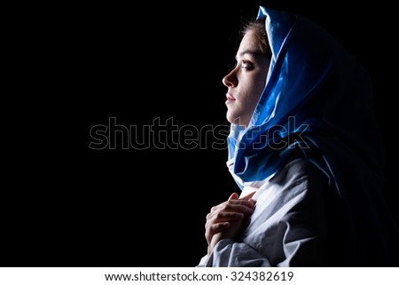 Virgin Mary with Blue Veil Praying on Black Background