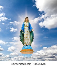 Virgin mary statue in blue sky background.