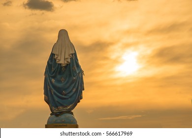 Virgin mary statue warm tone sunset scene