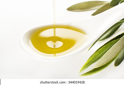 Virgin Olive Oil Pouring On White Spoon.