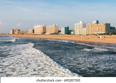 VIRGINIA BEACH, VIRGINIA - JULY 13, 2017:  High-rise hotels line the oceanfront boardwalk  as day breaks in this popular resort area.  