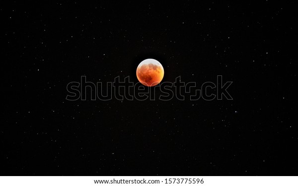 Virginia Beach, Virginia / United States -\
January, 21, 2019: \
The Super Wolf Blood Moon. Image depicts the\
moon with stars in the background.\
\
Shot with: Sony A6300\
Lens:\
Sony 55-210 / 4.5-6.3