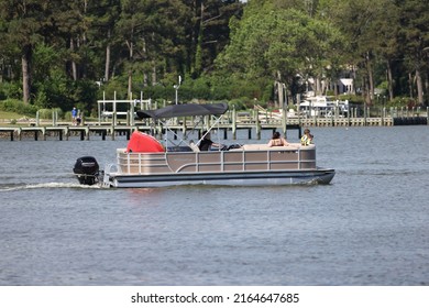 Virginia Beach, Virginia, USA - June 4, 2022: A Family Outing In A Bentley Pontoon Boat Passing Through The Narrows Out To Broad Bay In Virginia Beach.